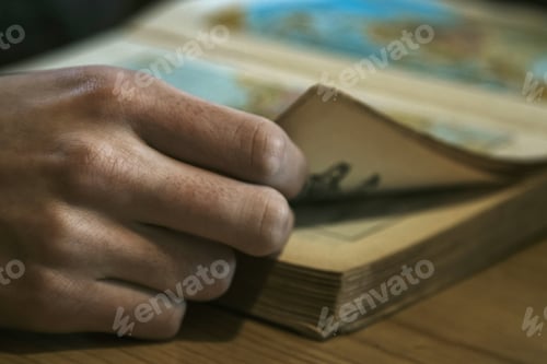 Preview: Closeup Of The Hand With The Leaves Of The Book