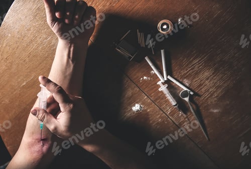 Preview: Man Shooting Heroin With Needle Syringe. Drugs Addict. Candle Burning With Matches And Cigarettes
