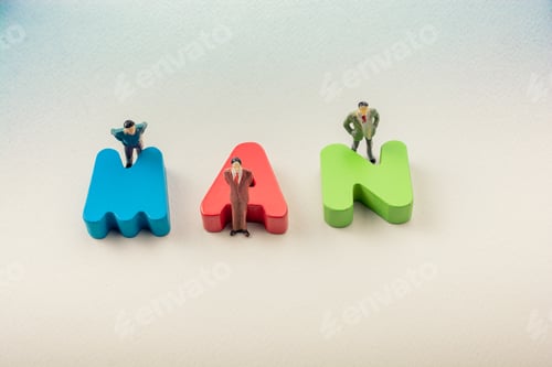 Preview: Tiny Figurine Of Men Beside Colorful Wooden Letters Say Man
