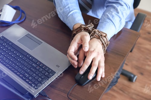Preview: Man'S Hands In Old Rusty Chains. In The Trap Of Office Work. Routine Job. Manager Near The Laptop.