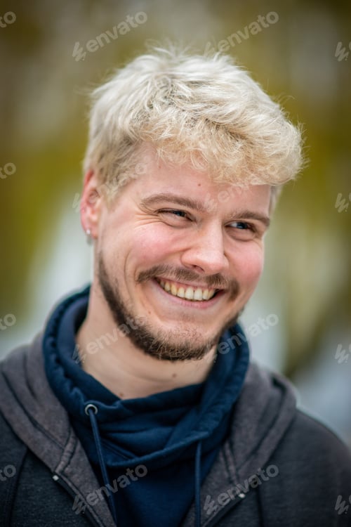Preview: Portrait Of A Cheerful Man Living With Hiv Standing In A Park In Hamburg, Germany