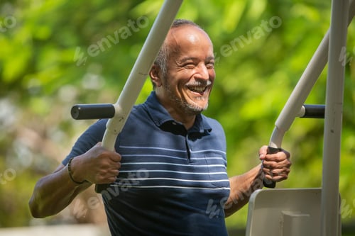 Preview: Smiling Senior Man Living With Hiv Exercising On The Chest Pressing Machine In The Park