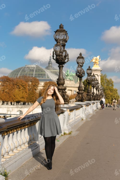 Preview: Nice Female Person In Grey Dress Near Street Vintage Lights And White Concrete Railing In France