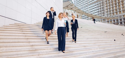 Preview: Financial Team Members Going Down Stairs With Tablet, Document Case And Talking By Smartphone In