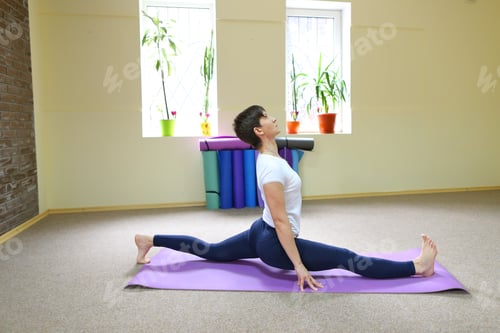 Preview: Beautiful Smiling Young Woman Of European Appearance Sits On Mat For Fitness And Performs Asanas