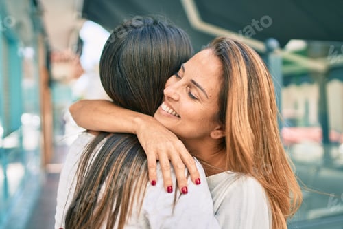 Preview: Beautiful Hispanic Mother And Daughter Smiling Happy Standing At The City.