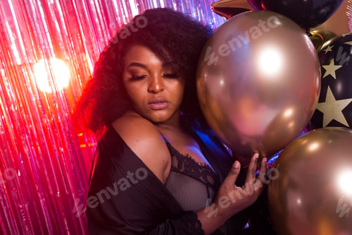 Preview: Portrait Of A Beautiful African American Woman Against Twinkling Background. Birthday Party