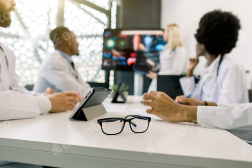 Preview: Blurred Image Of Multiethnical Concentrated Medical Team, Having A Meeting, And Listening The