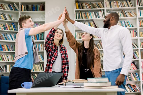 Preview: Happy Satisfied Attractive Young Multiethnic People, Students Or Coworkers, Standing At The Table
