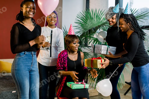 Preview: Young Beautiful African American Girls With Balloons And Hats Celebrate Birthday And Give Birthday