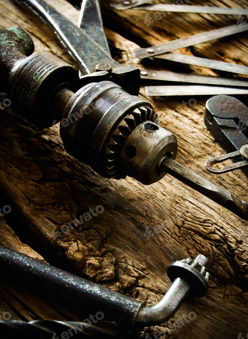 Preview: The Old Working Tool. Old Drill, Compasses, Pliers And Drills On A Wooden Background.