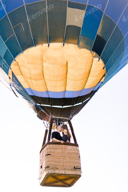 Preview: Happy Young Couple In Love Kissing In Hot Air Balloon Basket, While Enjoying Their First Flight