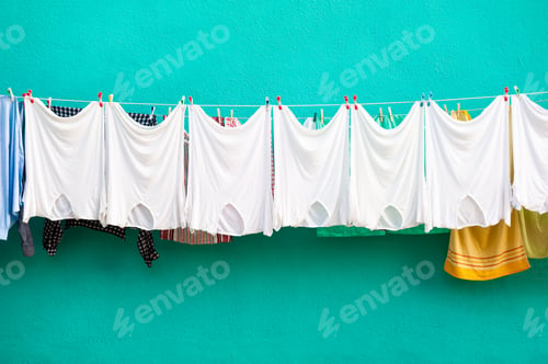 Preview: White T-Shirts Hanging On A Clothesline Against The Turquoise Facade Of The House. Burano Island