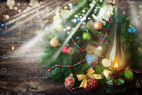 Preview: Vintage Glowing Lantern With Decorated Christmas Evergreen Wreath On Wooden Background, Low Key