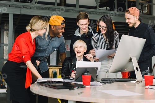 Preview: Diverse Group Of Business People Meeting Together At Modern Office. Woman In Black Hat Showing Her