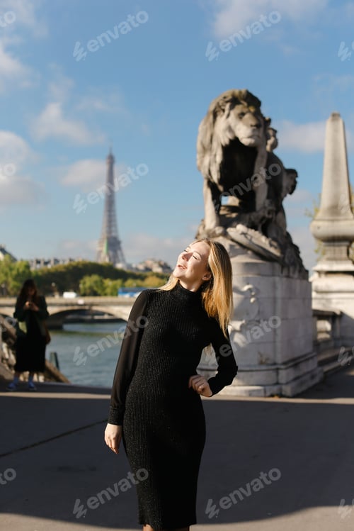 Preview: Beautiful Caucasian Woman Wearing Black Dress And Standing Near Statue Of Lion In Eiffel Tower