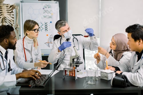 Preview: Team Of Multiethnic Scientists In Lab Coats In Modern Laboratory Conduct Medical Research In Search