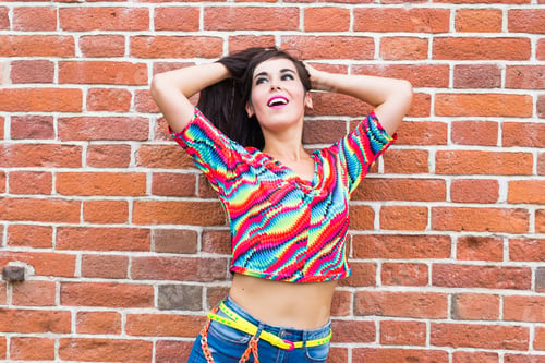 Preview: Fashion And Urban Style Concept - Portrait Of A Beautiful Woman In Blue Jeans Against A Brick Wall.
