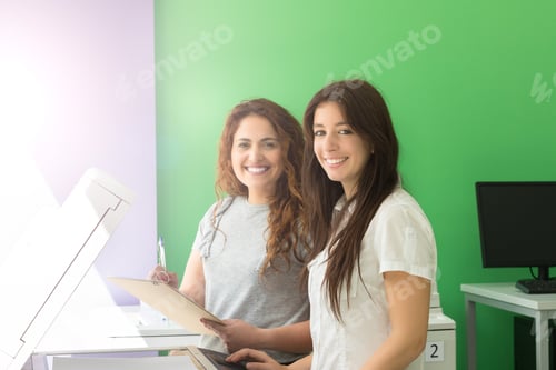 Preview: Two Students At A Copy Center Taking Some Copies For Their Final Exams
