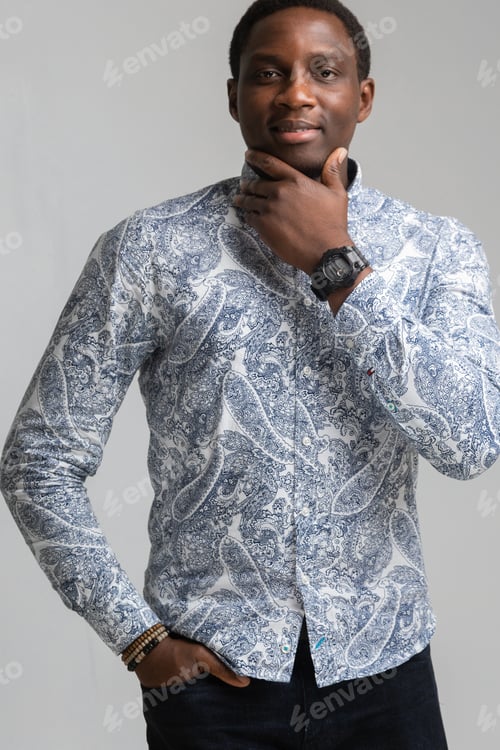Preview: Portrait Of Dark-Skinned Young Man Holding His Chin And Looking Straight Isolated On White