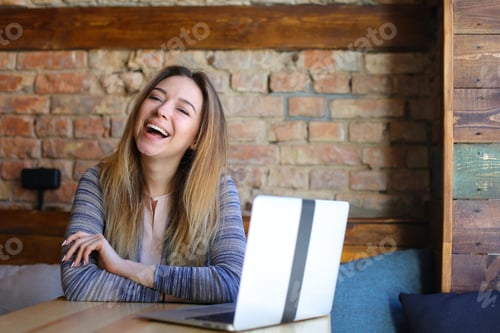 Preview: Happy Girl Using Laptop At Cafe With Brick Wall Background. Concept Of Positive Emotions And Modern