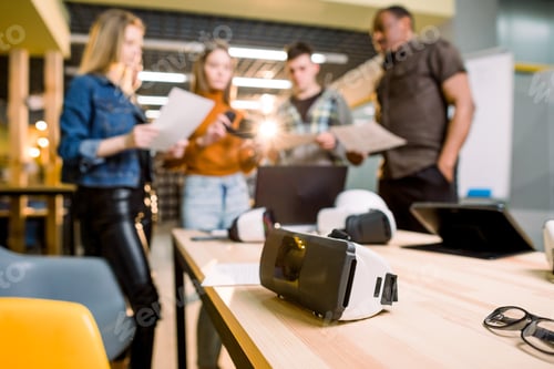 Preview: Blurred Image Of Five Multiethnical Business Persons Are Developing A Project Using Modern Gadgets