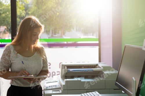 Preview: A Young Student At A Copy Center Taking Some Copies For Her Final Exams