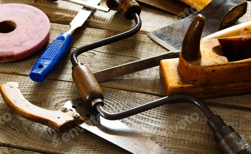 Preview: The Old Working Tool. Many Old Working Tools ( Saw, Plane And Others) On A Wooden Background.