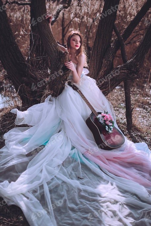 Preview: Beautiful Romantic European Girl With Guitar With Flowers Inside, Posing Outdoors. Concept Of Music