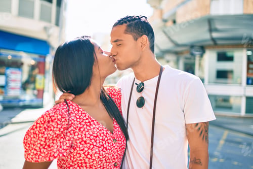 Preview: Young Latin Couple Smiling Happy Hugging And Kissing At Street Of City.