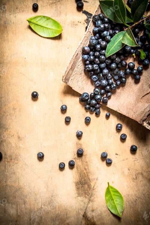 Preview: Blueberries With Leaves . On A Wooden Background.