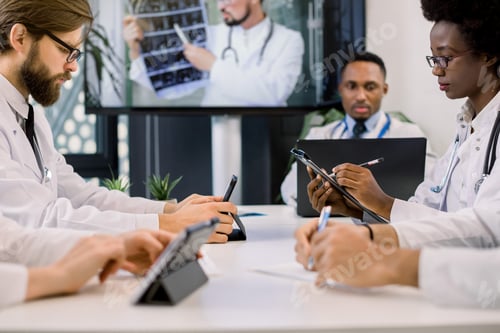 Preview: Cropped Image Of Team Of Multiracial Doctors Using Video Screen Projector During Conference