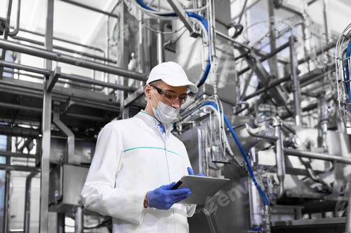 Preview: Man In A Mask And A Bathrobe Stands With A Tablet In His Hands At The Dairy Plant