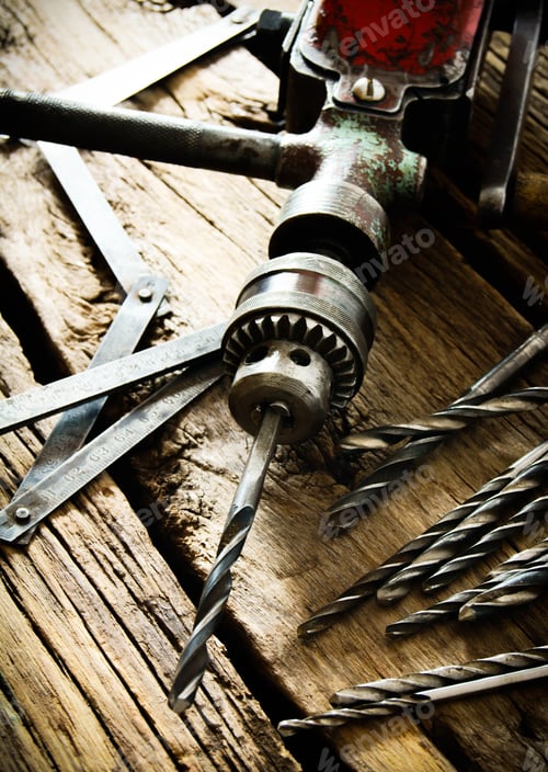 Preview: Vintage Hand Drill and Bits on Wood Surface