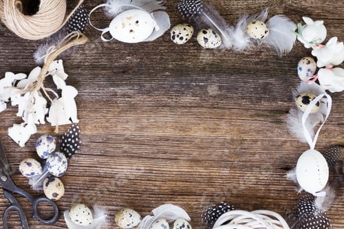 Preview: Easter Eggs, Rabbits And Feathers On Wooden Table Frame With Copy Space
