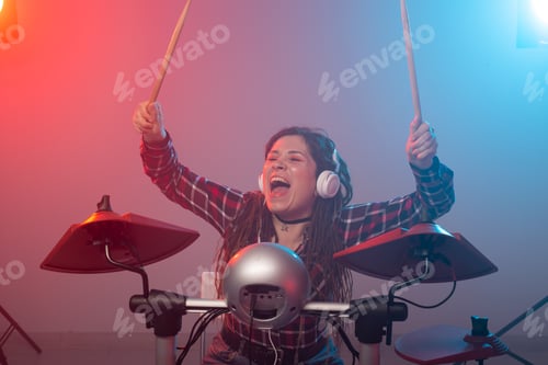 Preview: Emotions, Music, Hobbies And People Concept - Young Woman Playing The Electronic Drum Set In Studio