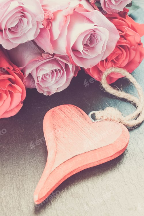 Preview: Blooming Pink Roses Laying On Black Stone Table With Red Heart, In Earth Tones