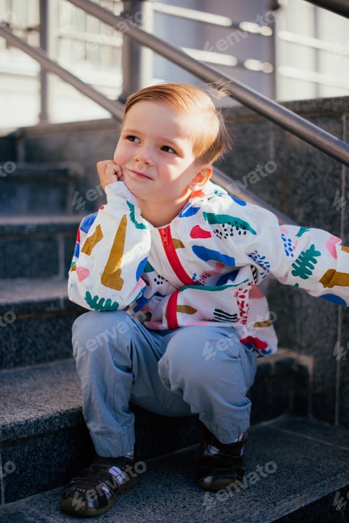 Preview: A Young Cute Happy 4 Years Old Boy Posing And Playing Outside, Wearing Colorfull Jacket