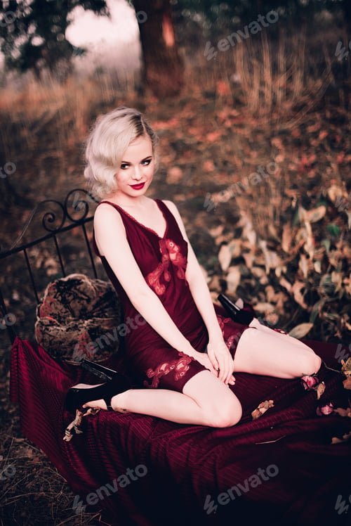 Preview: Beautiful And Elegant Blonde Woman With Red Lips And Hair Waves Wearing Wine Red Nightie Posing On