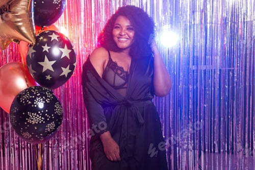 Preview: Portrait Of A Beautiful African American Woman Against Twinkling Background. Birthday Party