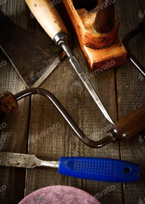 Preview: The Old Working Tool. Many Old Working Tools ( Saw, Plane And Others) On A Wooden Background.