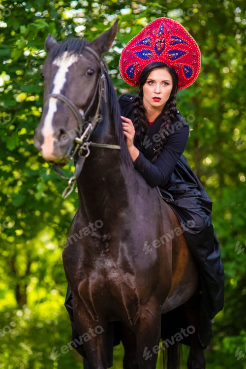 Preview: Gorgeous Model In Russian Style Kokoshnik Straddling On The Thoroughbred Horse. Posing Against