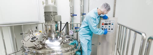 Preview: Wide-Screen Picture, Scientist In Blue Lab Suit Check Control Panel Near Big Chromed Tanks