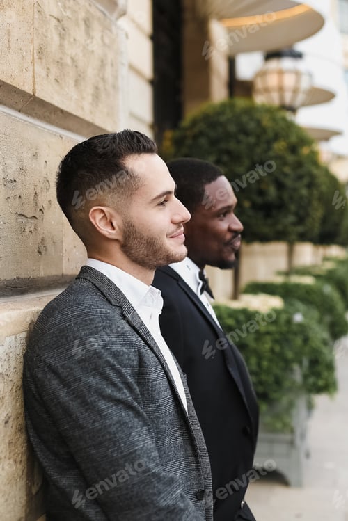 Preview: Afro American And European Gays Standing Near Building And Wearing Suits. Concept Of Lgbt And