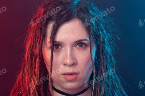 Preview: Style, Youth, People Concept - Young Cheerful Woman With Dreadlock Looks Like Rocker Over Dark