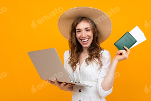 Preview: Tourist Smiling Girl Holds Passport In Hand And Looks At Tickets On A Laptop On A Yellow Background