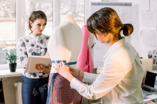 Preview: Back View Of Female Dressmaker Measuring Mannequin With Tape In Atelier Office. Talented Fashion