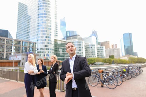 Preview: Satisfied Businessman Looking At Watch In La Defense Paris, . Concept Of Time Management And Biz.