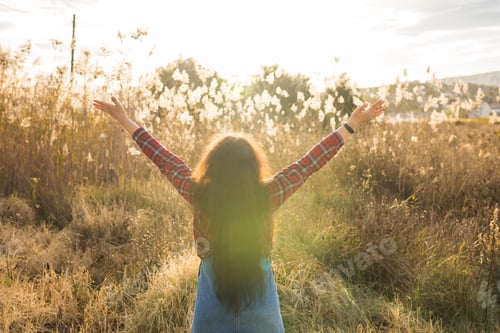 Preview: Summer, Freedom And Vacation Concept - Young Woman Enjoying Nature And Sunlight And Raised Arms In