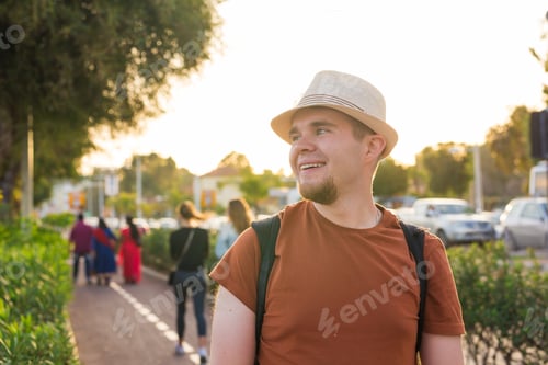 Preview: Man Traveler With Hat And Backpack In The City